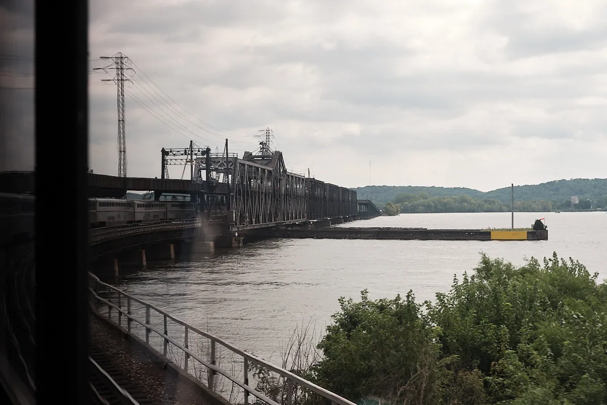 A curve in the train tracks leads into a long metal bridge. We get a good view of the train as it begins crossing over the Mississippi River.