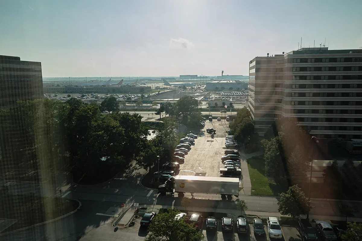 Looking out the high window in our hotel, we see the airport and the sun approaching the horizon.